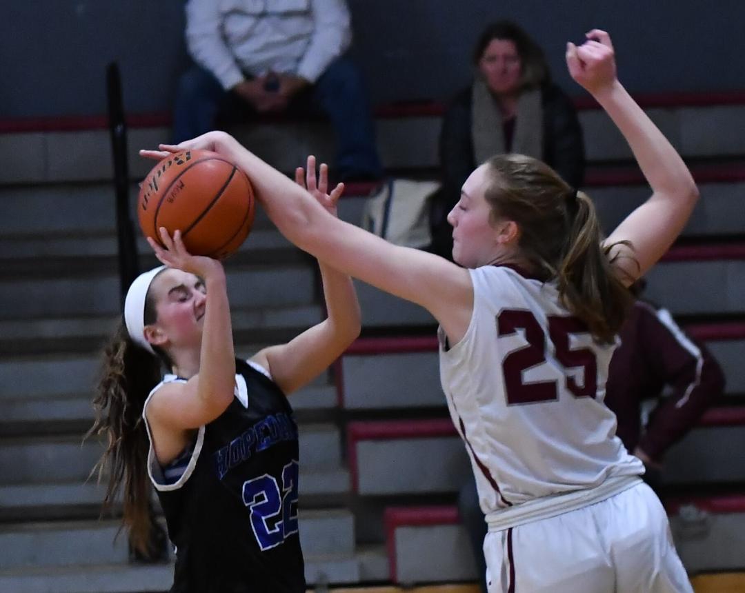 Abby Clark (No. 25), who provides a commanding presence in Millis’ frontcourt, blocks a shot against Hopedale. (Photo by STEVE BASSIGNANI) 