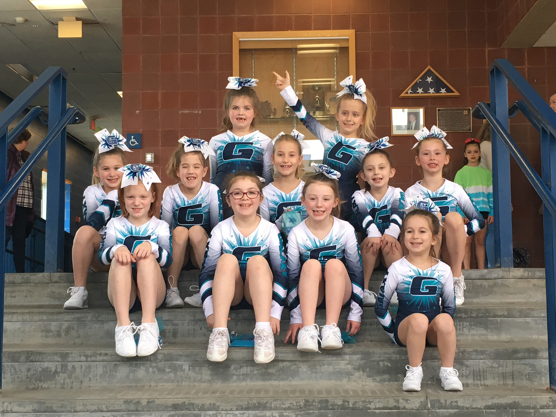 Holliston athletes were members of Galaxy All Stars team “Big Bang,” left, and “Fusion,” right, coached by Laura Bloise, which took third place in the Own the Thrown Cheering Competition in Newbury, Massachusetts. 