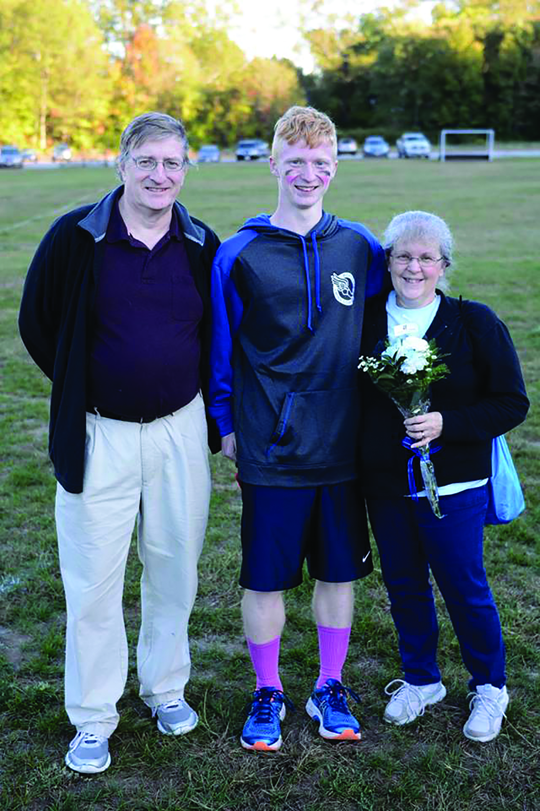 Christian De Boer with his mother (Laurel) and late father (Art) at the cross-country team’s senior day. (Photo by Steve Bassignani)