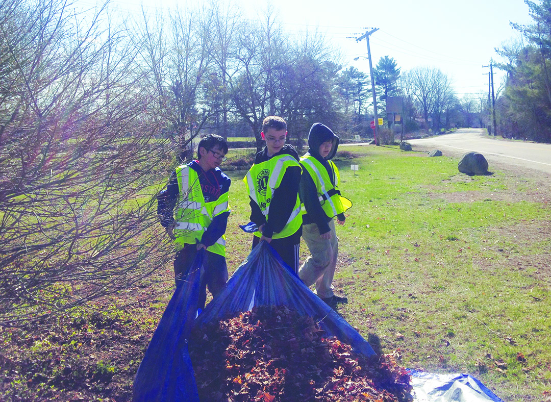 Each year, hundreds of town residents, including neighborhoods, friends, scouts and civic groups, participate in Millis Beautification Day. Shown, members of Millis Boy Scout Troop 15 spruce up an  entrance point to the town.