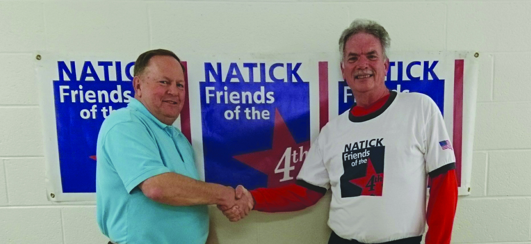 Grand Marshal Joe Landry (left) shakes hands with Chairman Peter Mundy