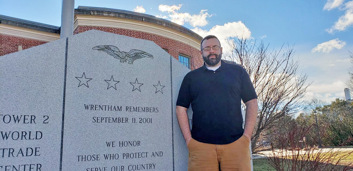 Wrentham Veterans’ Agent Mike Hennessy standing next to the town’s 9/11 memorial. (Photo courtesy Town of Wrentham)