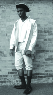 Shown is Dean College student Tylar Ibrahima Jahumpa, who recently reenacted the true-life role of Franklin slave Charles Paine. An exhibit on Paine at Dean College, put together by Franklin native Susan Elliott, will move to the Franklin Historical Museum for February, to coincide with Black History Month.