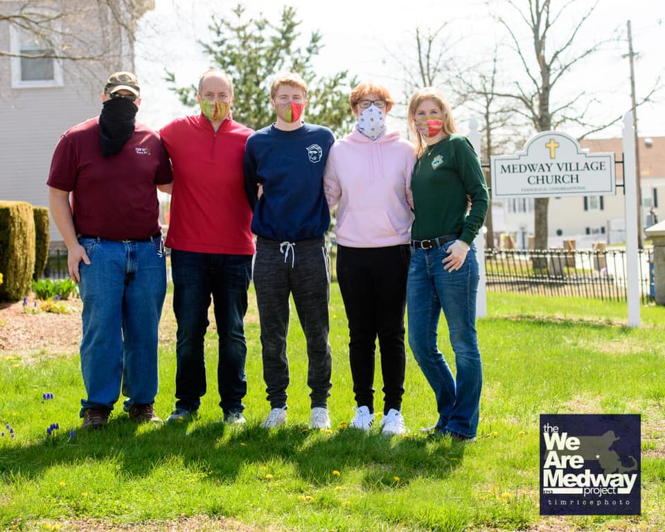 This photo by Tim Rice, was one of a Covid-19-era porch portrait endeavor that yielded $25,000 and 1,000 pounds of food for the two Medway food pantries (this includes a $5k donation from Medway Cable Access). From left to right, Fred Hopke, Martin Dietrich, Liam Dietrich, Aidan Dietrich, Susan Dietrich. 