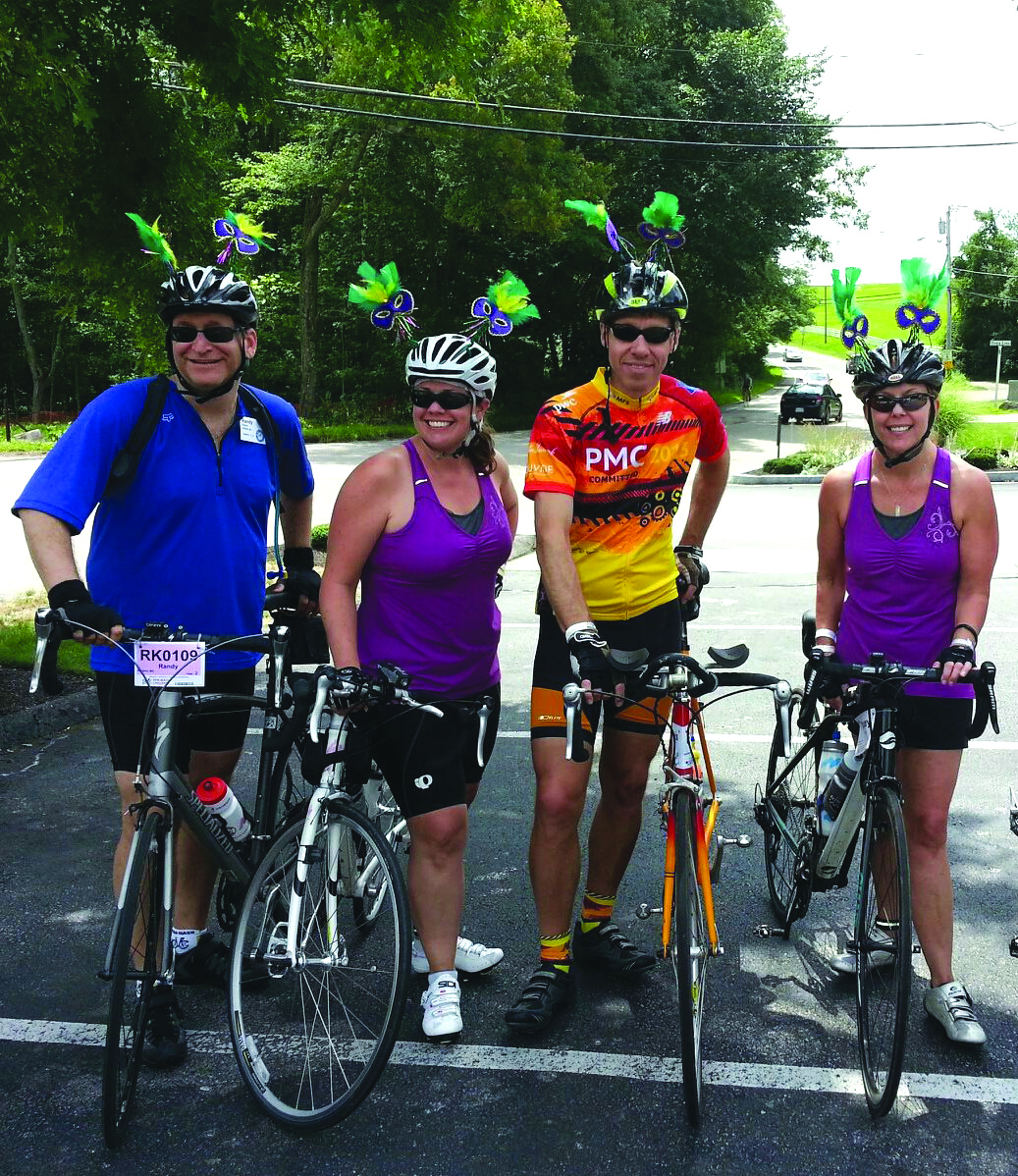 Randy, Lisa, Francois and Tracey (l to r) chose Mardi Gras-theme helmet decorations one year to capture the spirit of fun and camaraderie generated during the PMC. These friends are among thousands who ride to raise money for the Dana-Farber Cancer Institute. (Photo/Submitted)