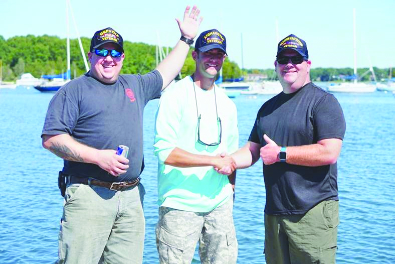 Rifles to Rods: Ryan Puzo (center) with two vets on a striped bass fishing trip in Narragansett Bay. (Photo/Ryan Puzo)