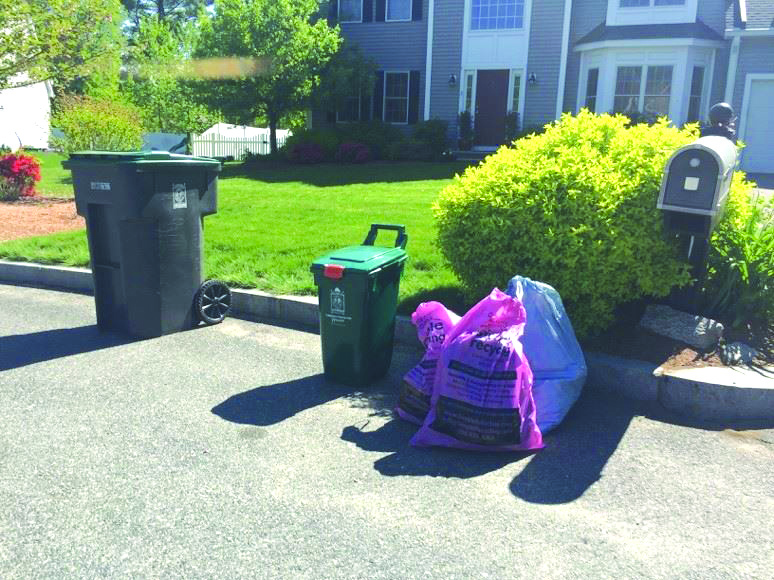 Simple Recycling bags alongside trash and recycling bags outside of a Natick home. (Photo/Courtesy of the Natick Department of Public Works)